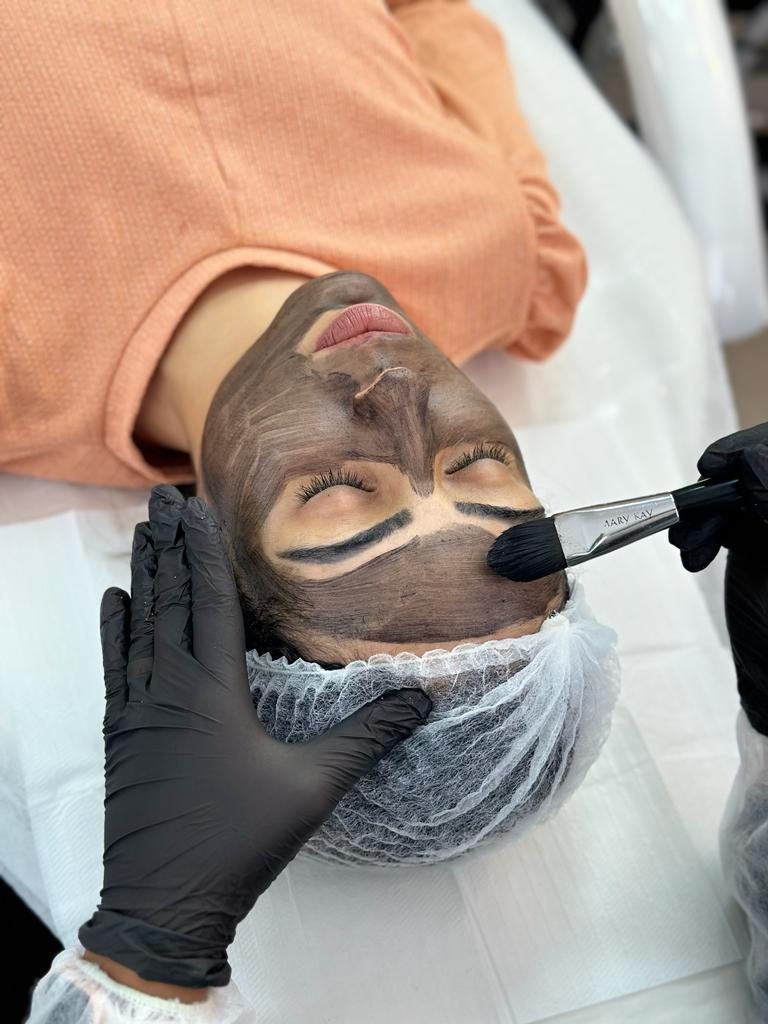 Aplicação da máscara de carbono no rosto para o peeling de Hollywood